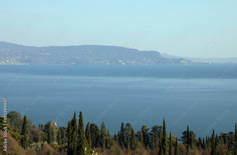 Obraz premium panorama of Lake Garda with the mountains reaching the shore in northern Italy