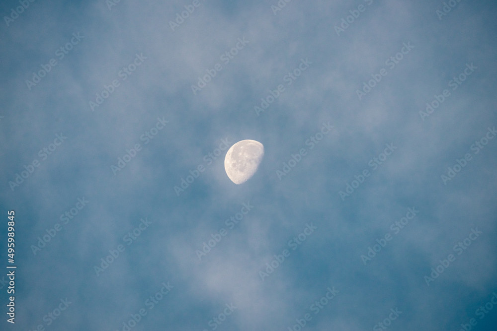 blue sky with white clouds and half moon at morning blue sky with white clouds and half moon at morning