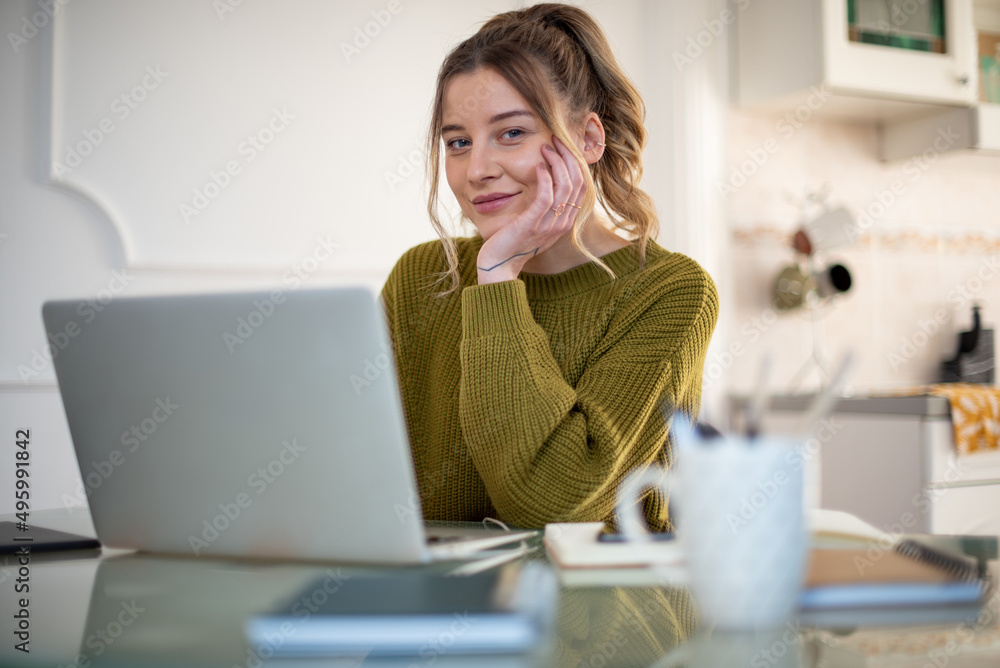 Woman working from a home on her a laptop Woman working from a home on her a laptop