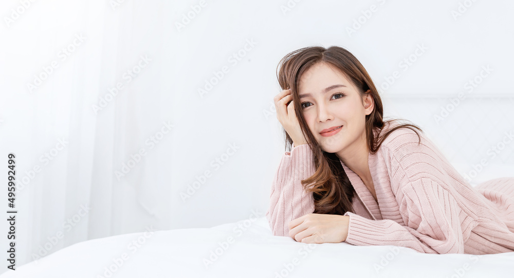 Portrait young beautiful asian woman relax in bedroom. Smile happy asian teenage girl with clear perfect japanese korean makeup skin isolated on white background. Cold winter lifestyle concept.
