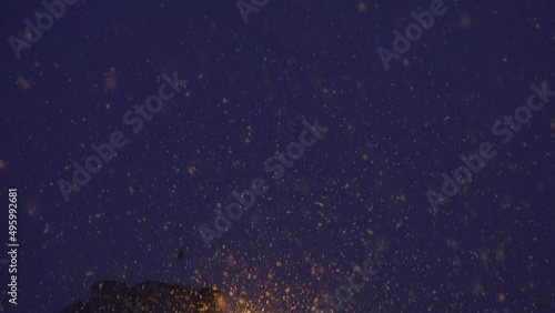 Night time snow concept. Snowflakes, snowfall on winter time. Rain storm, wind and dark night.