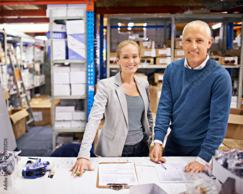 We cant keep our shelves stocked quickly enough. Shot of managers at work supervising a shipping and distribution business.