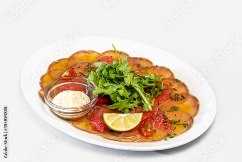 Salmon carpaccio with tomatoes, grapefruit and parsley
