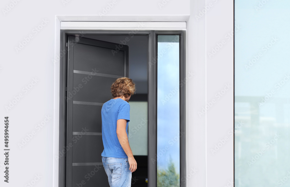 Man opening the door of her home.Inviting the guests Man opening the door of her home.Inviting the guests