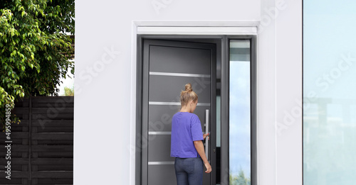 Beautiful woman opening the door of her home.