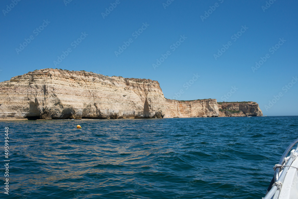 Impressive cliffs on Algarve coast seen from a boat. Portugal