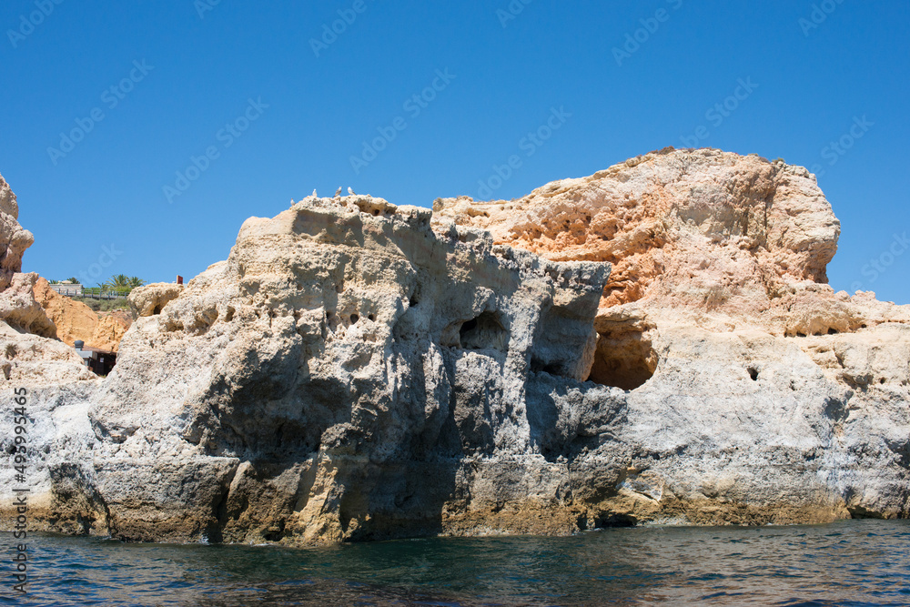 Close up of the rocky coast at Algarve, Portugal, seen from the ocean.