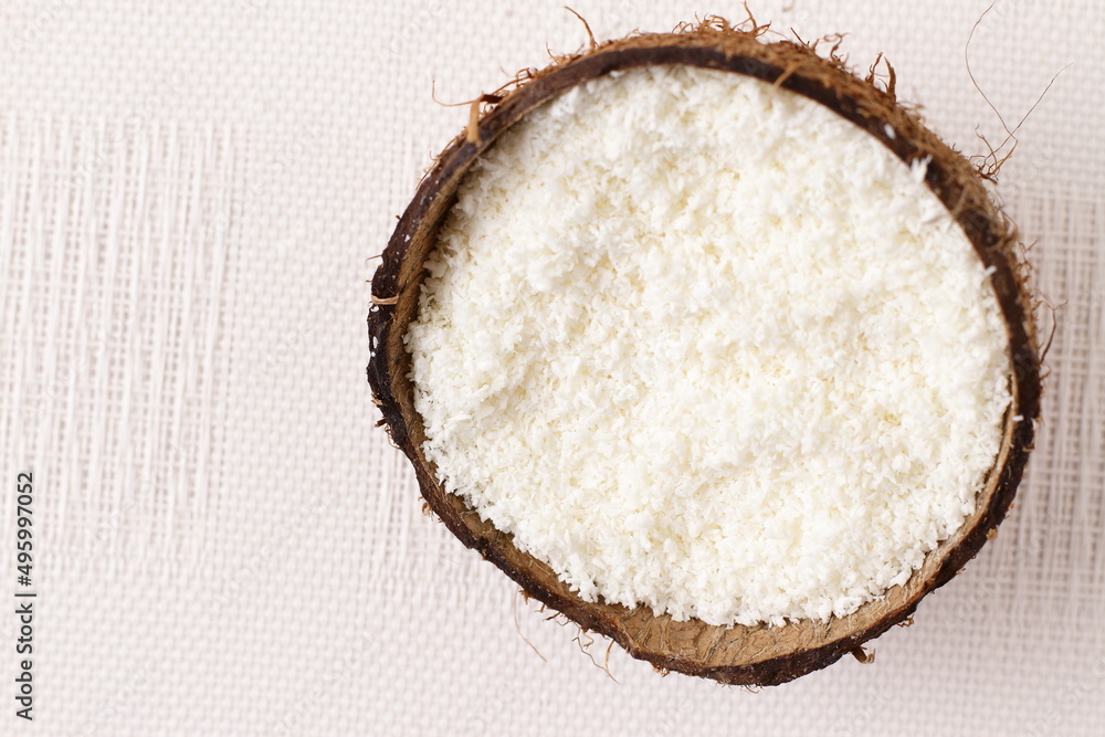 Natural coconut flakes in shell, copy space Natural coconut flakes in shell, copy space
