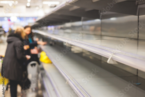 View of empty supermarket shelves, grocery store work stoppage closes, sanctions and embargo, panic buying with supplies and goods shortage, food crisis and deficit concept © tsuguliev
