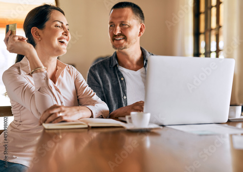 Their financial budget is looking up. Cropped shot of a married couple planning their financial budget at home.