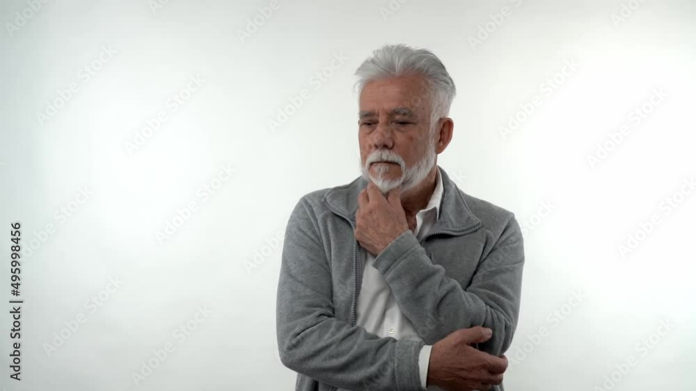 Portrait of an elderly caucasian stylish man in a sad depressed state posing in the studio on a white background. Concept of trend aging. Portrait of an elderly caucasian stylish man in a sad depressed state posing in the studio on a white background. Concept of trend aging.