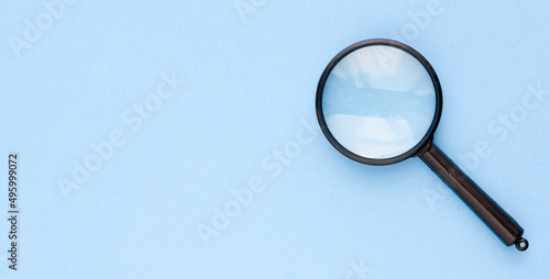 Black magnifier on a blue background.