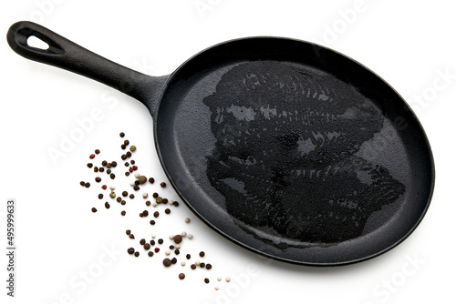 Wet imprint of raw fish fillets in a cast iron pan