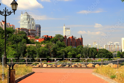 Beautiful tall white towers, skyscrapers, red buildings, against sky in summer and spring. Best view of Dnipro city street, Dnepropetrovsk, Ukraine photo