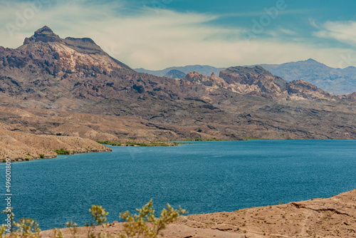 Принти на полотні Nelson, Nevada, USA - May 21, 2011: Both dry desert shorelines of blue Colorado River under blue cloudscape