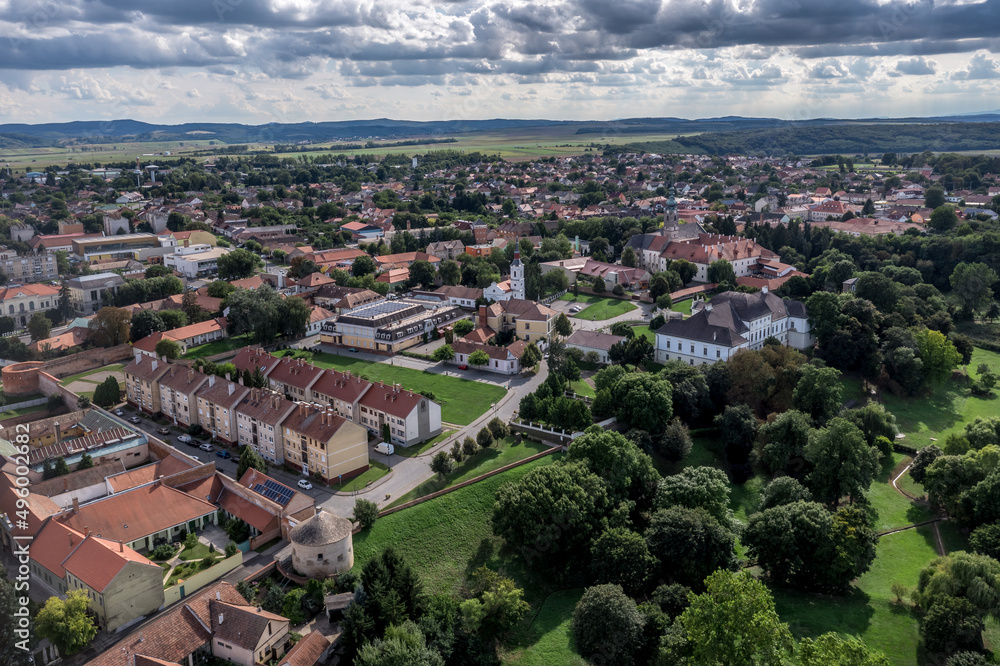 Aerial view of Szecseny in Nograd county Hungary with walled medieval center, modern block houses typical Hungarian small town