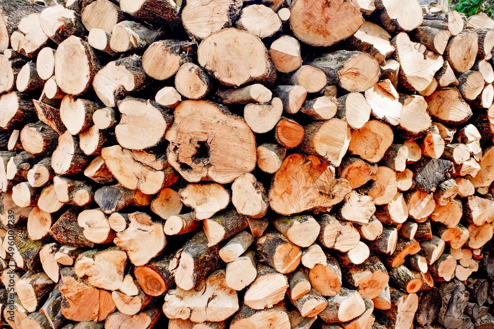 Pile of perfectly cut and stacked logs of wood to fuel the heating fire. Pile of perfectly cut and stacked logs of wood to fuel the heating fire.