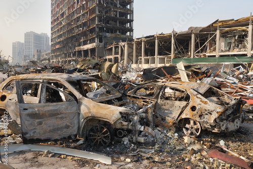 Russia war damage building destruction city war ruins city damage car. Terror attack bomb shell of civilian bombed. Disaster area. 2022 Russian invasion of Ukraine war torn city destroyed car burn out