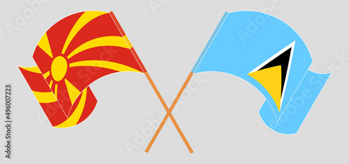 Crossed and waving flags of North Macedonia and Saint Lucia