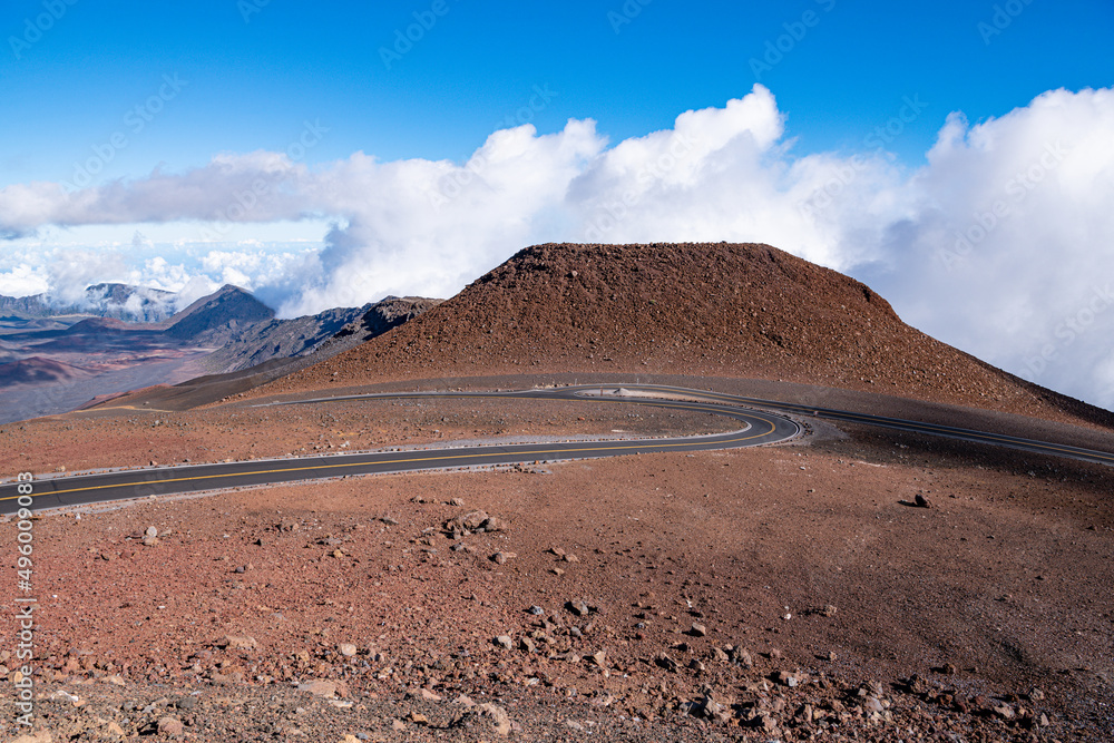 Curving roads meet at a junction in a barren volcanic landscape depicting concepts of choice, decision, direction, change - Haleakala Crater, Maui, Hawaii