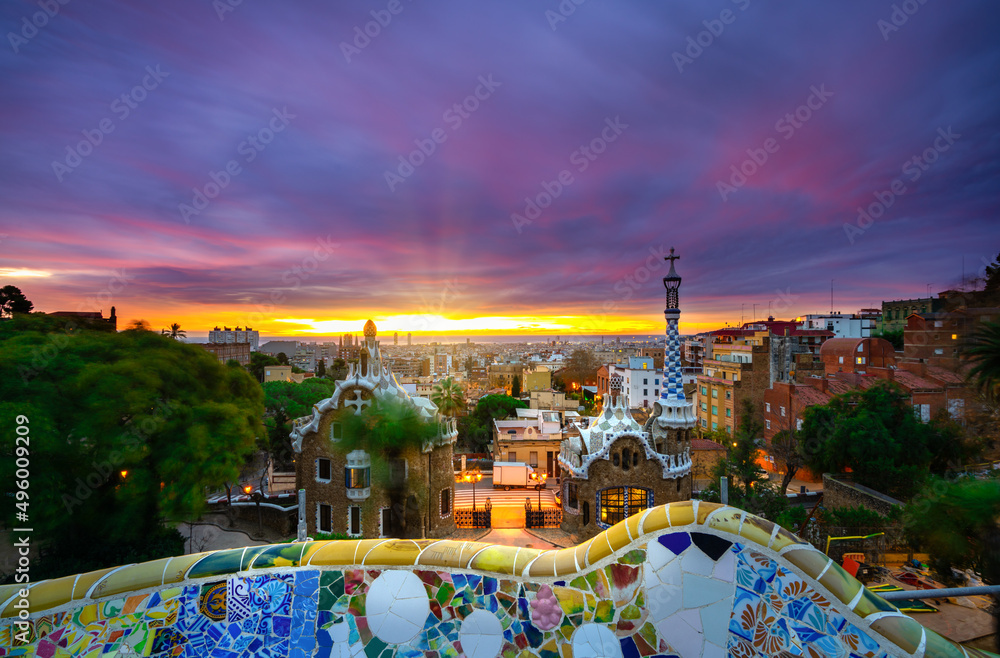 Fototapeta premium Beautiful sunrise in Barcelona seen from Park Guell. Park was built from 1900 to 1914 and was officially opened as a public park in 1926. In 1984, UNESCO declared the park a World Heritage Site