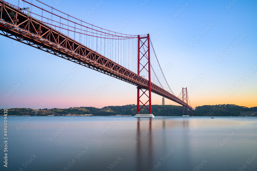 The 25 de Abril bridge at sunset over the Tajo River in Lisbon. Portugal The 25 de Abril bridge at sunset over the Tajo River in Lisbon. Portugal