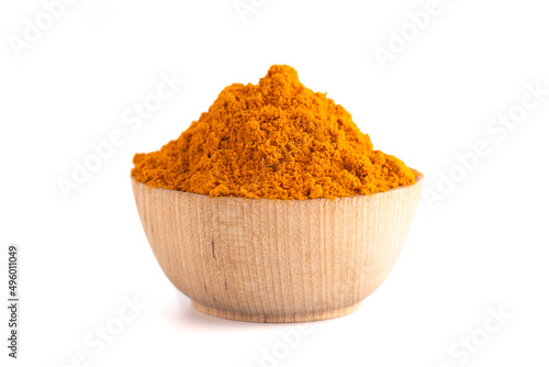 A Bowl of Ground Turmeric Powder on a White Background