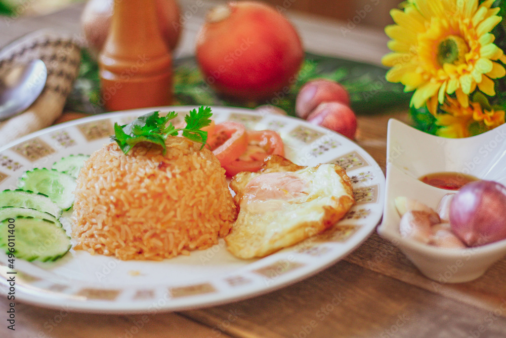 Fried Rice with Fried Egg Put on the wooden table and the tomatoes, cucumbers, garlic, shallots Fried Rice with Fried Egg Put on the wooden table and the tomatoes, cucumbers, garlic, shallots