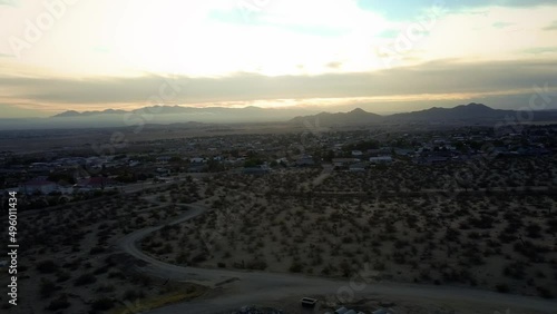 A drone flight footage near the arid and hot California high desert town of Apple Valley during a summer sunset. photo