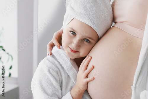 Little girl with her pregna...