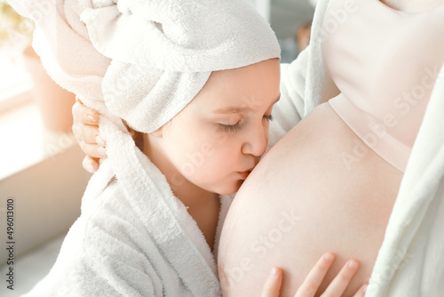 Little girl with her pregna...