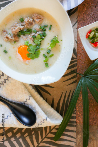 Chinese style porridge or porridge and fried dough stick or fried dough stick or donut or fried bread placed on a wooden table. Thai street food is called 