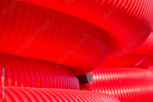 Red plastic pipes are coiled photo