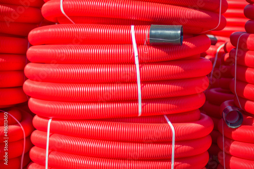 Red plastic pipes are coiled photo