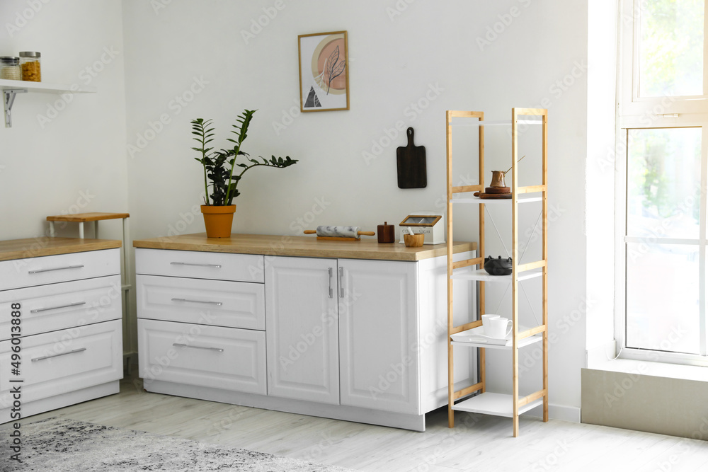 Interior of light modern kitchen with shelf unit Interior of light modern kitchen with shelf unit
