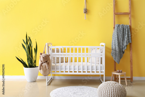 Interior of modern children's room with crib photo