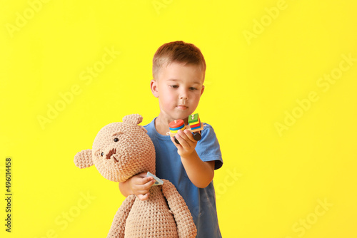 Cute little boy with toys o...