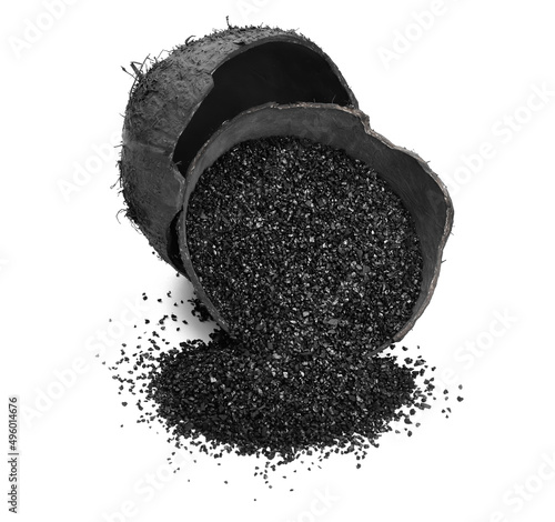 Fotografie Coconut shells with activated carbon on white background