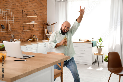 Funny bald man drinking bee...