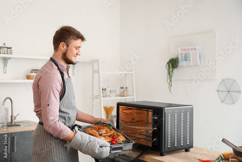 Young man putting baking di...