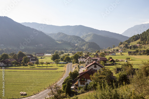 Aerial panorama of Ljubno ob Savinji, a typical central europea village of Slovenia, with individual houses, farmhouses, buildings and fields and julian alps mountains in a agricultural environment photo
