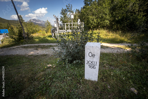 Austrian Boundary border marker stone in paulitschattel at the austrian border with slovenia in the Schengen area, with the initial Oe meaning Oesterreich, Austrian in german.... photo