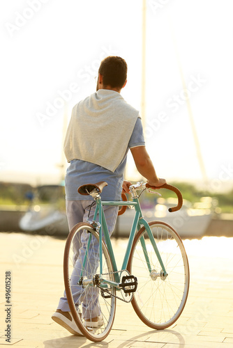 Handsome man with bicycle o...