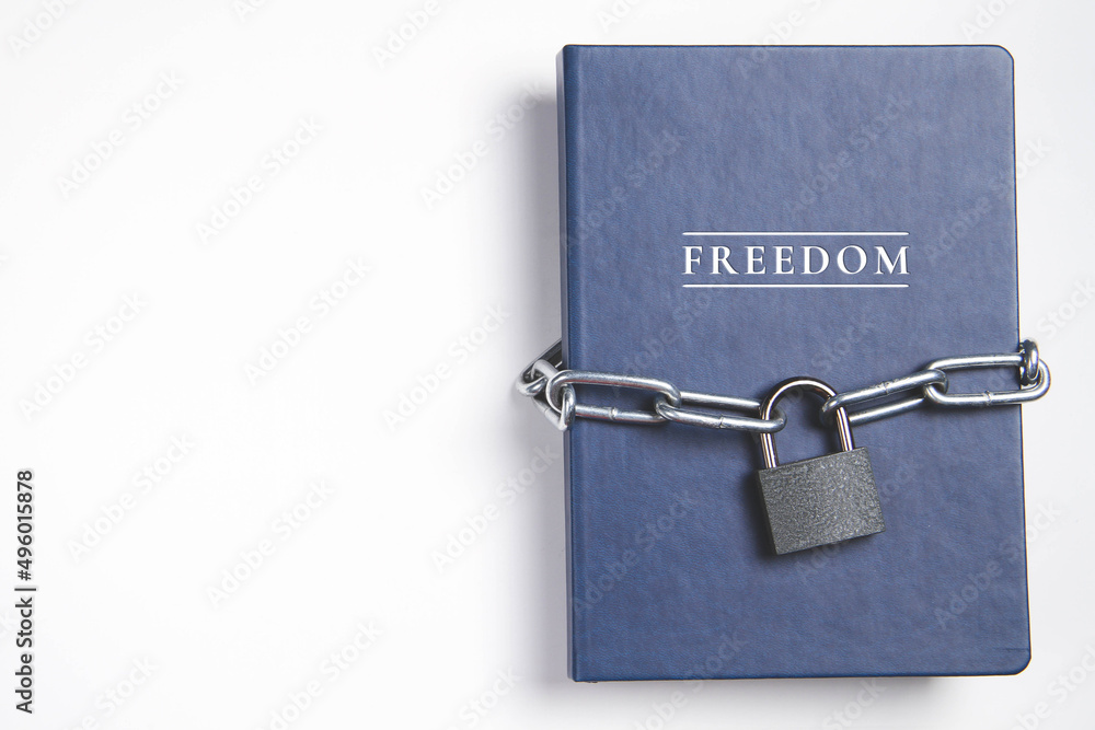Freedom. Book with lock. A closed book is banned. Chain on the book. Freedom. Book with lock. A closed book is banned. Chain on the book.
