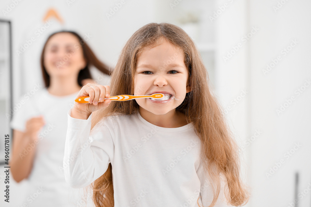 Funny little girl brushing teeth in bathroom, closeup Funny little girl brushing teeth in bathroom, closeup
