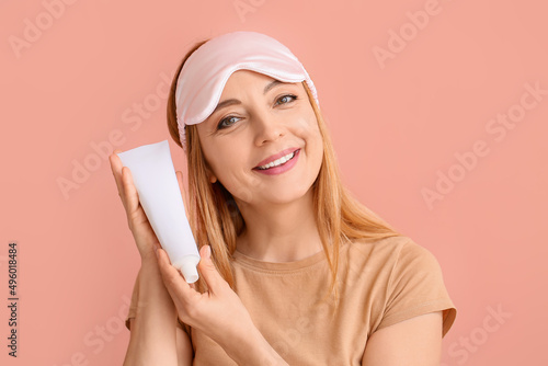 Smiling woman in sleep mask...