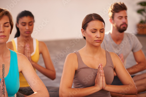 Meditation is the key to energy. A group of people doing yoga together.