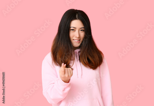 Young Asian woman in hoodie...