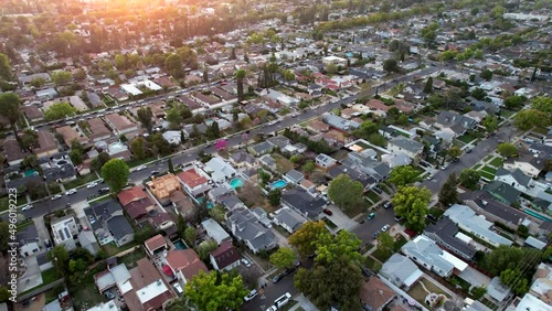 Suburban housing residential development aerial view. Drone footage flying over middle class neighborhood houses urban sprawl.