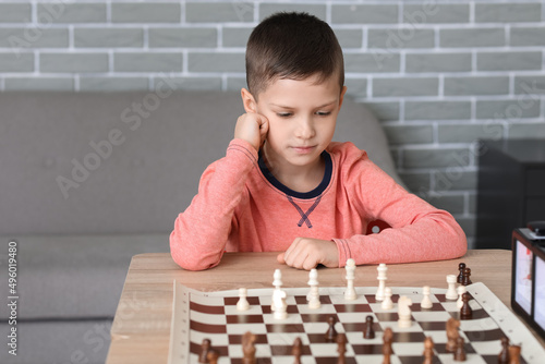 Little boy playing chess du...